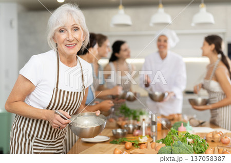 Mature woman holding bowl in her hands Mature woman holding bowl in her hands 137058387