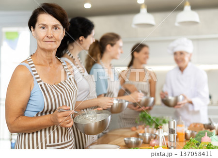 Mature woman holding bowl in her hands 137058411