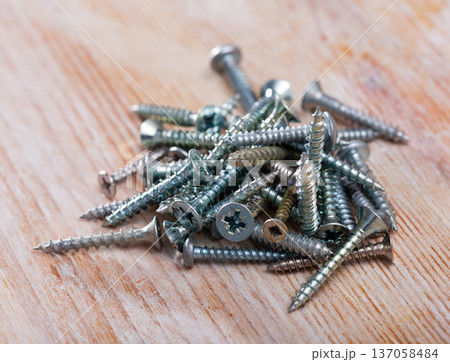 Closeup of golden, silver and black screws 137058484