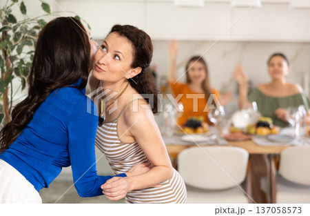 Two women greet each other when meeting Two women greet each other when meeting 137058573