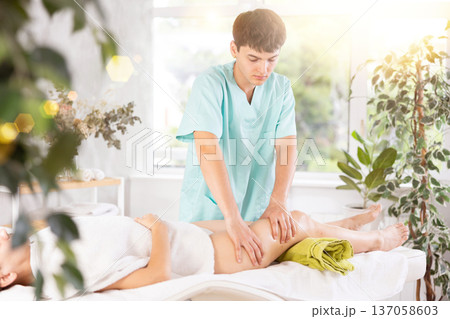 Relaxing professional massage for woman in spa salon Relaxing professional massage for woman in spa salon 137058603
