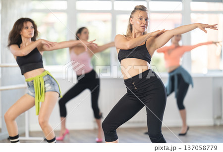 Adult woman dancing high heels in group Adult woman dancing high heels in group 137058779