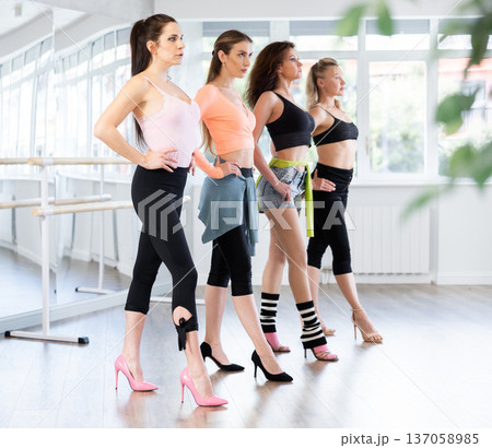 Women perfecting walk during high heels dance class 137058985