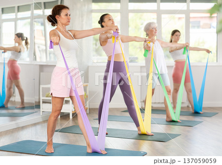 Adult woman exercising with pilates band 137059059