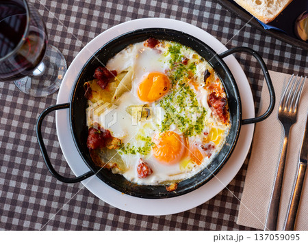 Scrambled eggs with bacon and herbs on table Scrambled eggs with bacon and herbs on table 137059095