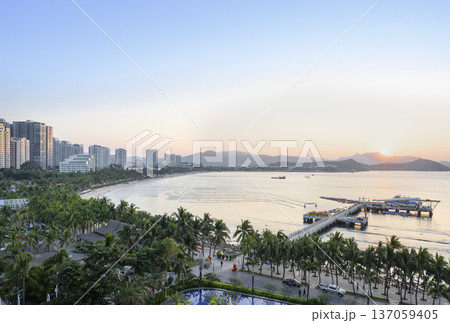 Sunrise over Dadonghai Bay in tropical Sanya City on Hainan Island in China Sunrise over Dadonghai Bay in tropical Sanya City on Hainan Island in China 137059405