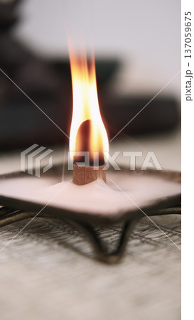 Spiritual therapy. Incense burner. Religious tradition fire yoga tools with smoke smoldering placed on defocused calming background. 137059675