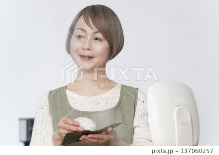 キッチンでおにぎりを握るシニア女性 キッチンでおにぎりを握るシニア女性 137060257