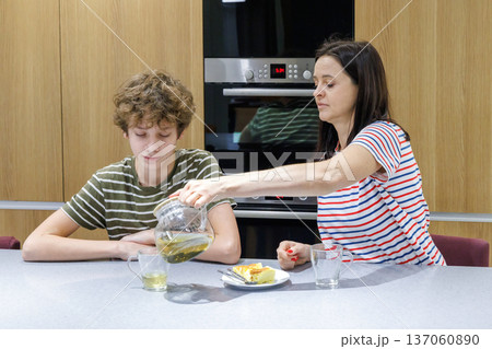 Mother and son drinking tea at home Mother and son drinking tea at home 137060890