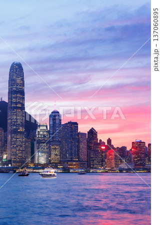 Hong Kong city skyline at sunset with glowing sky and skyscrapers 137060895