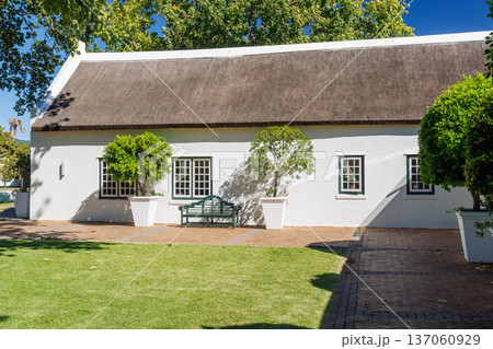 Cozy white house with thatched roof Cozy white house with thatched roof 137060929