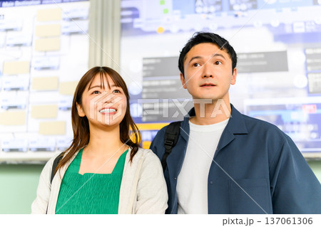 駅で案内板を見る二人 駅で案内板を見る二人 137061306