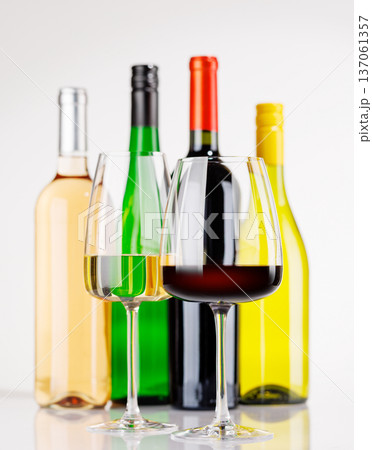 Different wine bottles and glasses on white background 137061357