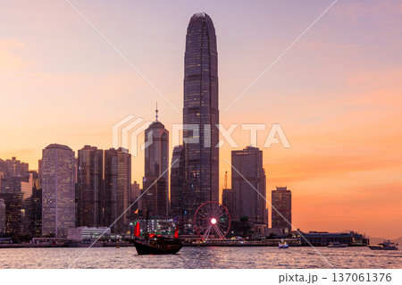 Hong Kong city skyline at sunset with glowing sky and skyscrapers 137061376