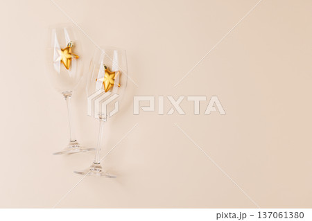 Champagne glasses and decor on beige background Champagne glasses and decor on beige background 137061380