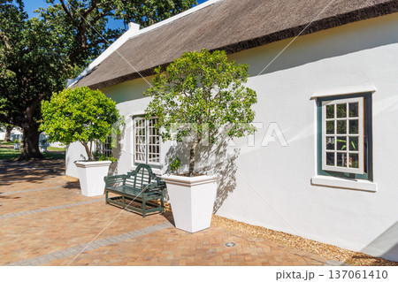 Cozy white house with thatched roof Cozy white house with thatched roof 137061410