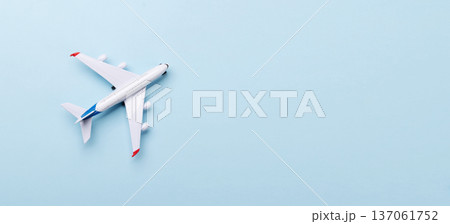 Toy passenger airplane on blue background Toy passenger airplane on blue background 137061752