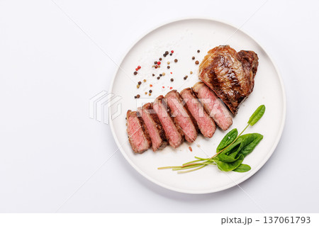 A perfectly cooked sliced striploin steak with a juicy, tender texture A perfectly cooked sliced striploin steak with a juicy, tender texture 137061793