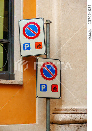 Parking signs displayed on a wall in a city with different parking rules for vehicles 137064085