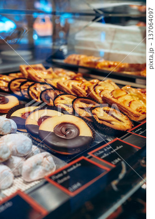 Fresh variety of pastries on display in a bakery during the afternoon Fresh variety of pastries on display in a bakery during the afternoon 137064097