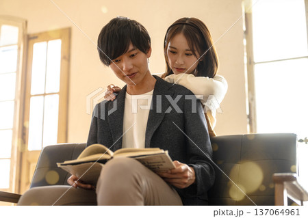寄り添い読書する男女 137064961