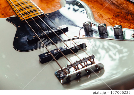 white electric bass guitar on wood background with copy space white electric bass guitar on wood background with copy space 137066223