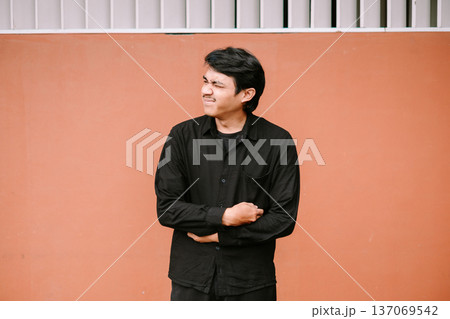 Young Man Grimacing in Pain Holding Stomach 137069542