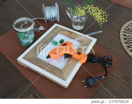 Sea glass for creating framed picture. Natural materials and recycling. Nature and ecology. Glue gun and other tools. Hobbies and creativity. Sea glass for creating framed picture. Natural materials and recycling. Nature and ecology. Glue gun and other tools. Hobbies and creativity. 137070028
