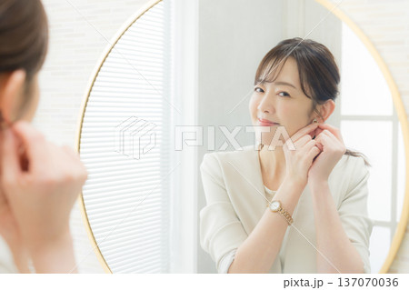 鏡を見てメイクする女性 鏡を見てメイクする女性 137070036