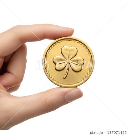 Hand presenting a shiny golden shamrock coin, isolated. Perfect for st. patrick's day wealth, irish luck, and treasure concepts 137071125
