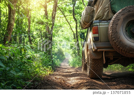 Rugged Off-Road Vehicle Traversing a Lush Green Forest Path with Large Tires Rugged Off-Road Vehicle Traversing a Lush Green Forest Path with Large Tires 137071855