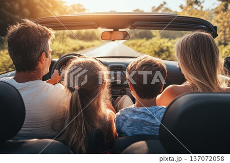 Family Enjoying Scenic Road Trip in Countryside Landscape During Golden Hour 137072058
