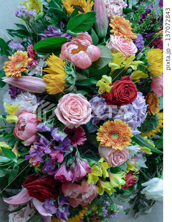 A rich tapestry of color, this mixed arrangement features a curated selection of red and pink roses, a soft lilac hydrangea, and bold orange gerbera daisies, balanced by delicate carnations and A rich tapestry of color, this mixed arrangement features a curated selection of red and pink roses, a soft lilac hydrangea, and bold orange gerbera daisies, balanced by delicate carnations and 137072843
