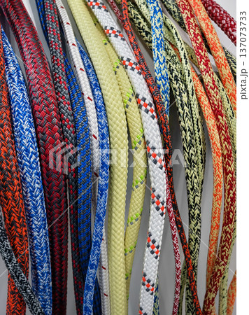 Different types of ropes in various colors arranged neatly on a display for sale or showcase in a shop or market Different types of ropes in various colors arranged neatly on a display for sale or showcase in a shop or market 137073733