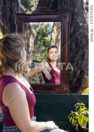 young pretty woman in garden with big mirror, lifestyle people concept young pretty woman in garden with big mirror, lifestyle people concept 137074301