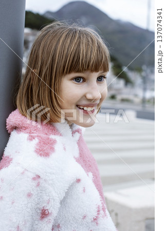 little cute blond girl curious smiling playing outside on sea, lifestyle people concept little cute blond girl curious smiling playing outside on sea, lifestyle people concept 137074341