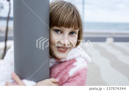 little cute blond girl curious smiling playing outside on sea, lifestyle people concept little cute blond girl curious smiling playing outside on sea, lifestyle people concept 137074344