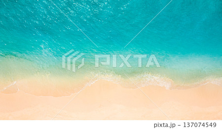 Summer seascape beautiful waves, blue sea water in sunny day. Top view from drone. Sea aerial view, amazing tropical nature background. Beautiful bright sea with waves splashing and beach sand pattern Summer seascape beautiful waves, blue sea water in sunny day. Top view from drone. Sea aerial view, amazing tropical nature background. Beautiful bright sea with waves splashing and beach sand pattern 137074549