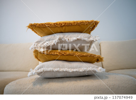 Stack of decorative pillows on sofa in cozy Scandinavian living room 137074949