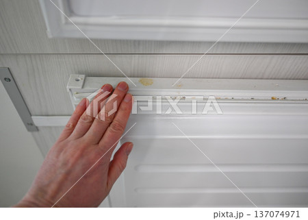 Dirty freezer door seal with food stains requiring deep cleaning and hygiene maintenance 137074971