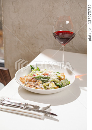Caesar salad with grilled chicken and wine Caesar salad with grilled chicken and wine 137075729