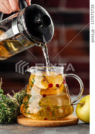 Hot herbal tea with apple and cranberries 137075738