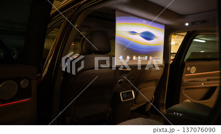 A projector opens in the car's interior for passengers to watch movies. A projector opens in the car's interior for passengers to watch movies. 137076090