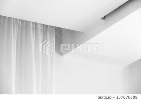 A bright minimalist white interior features a soft curtain 137076309