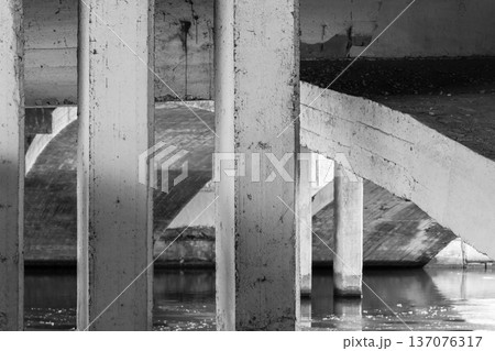 Abstract industrial background photo featuring rugged concrete pillars Abstract industrial background photo featuring rugged concrete pillars 137076317