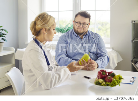 Doctor counseling patient on nutrition and weight management with vegetables Doctor counseling patient on nutrition and weight management with vegetables 137076368