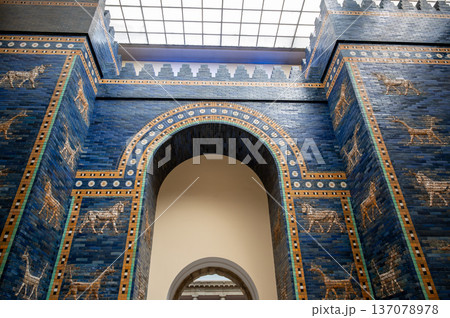 Berlin, germany, august 16, 2023. Ancient ishtar gate, a reconstruction from babylon, exhibiting intricate blue glazed bricks with bas-relief animals at pergamon museum Berlin, germany, august 16, 2023. Ancient ishtar gate, a reconstruction from babylon, exhibiting intricate blue glazed bricks with bas-relief animals at pergamon museum 137078978