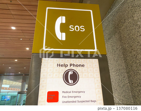 Help phone sign displaying SOS symbol and emergency instructions for medical, fire, and unattended bag situations in a public space Help phone sign displaying SOS symbol and emergency instructions for medical, fire, and unattended bag situations in a public space 137080116