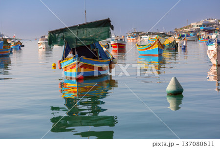 Traditional luzzu fishing boats in Marsaxlokk harbor Malta 137080611