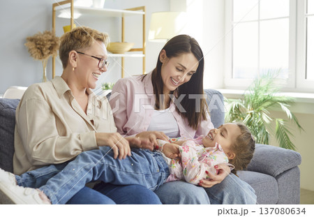 Happy Grandmother And Daughter Tickling At Home Happy Grandmother And Daughter Tickling At Home 137080634